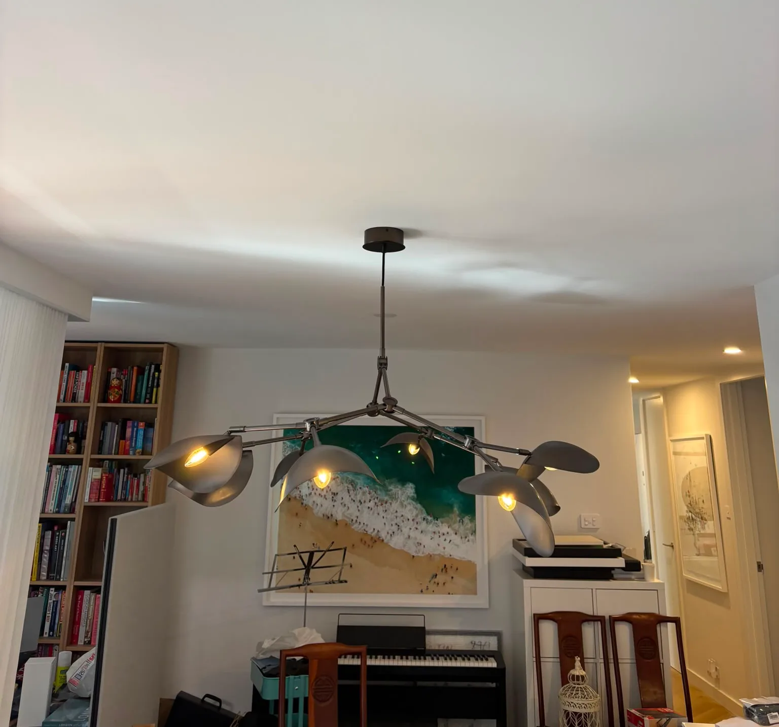 Modern multi-arm chandelier with grey metallic finish in a living room