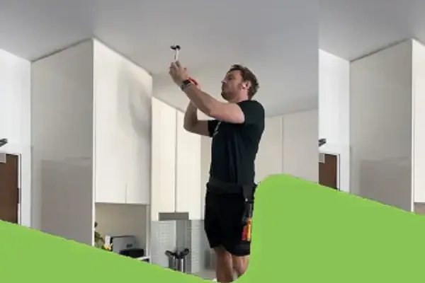 Coleman Electrical electrician repairing a ceiling fixture in a Sydney home