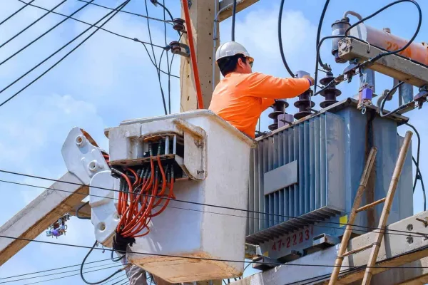 Electrician inspecting electrical wiring during a safety check in a Sydney home